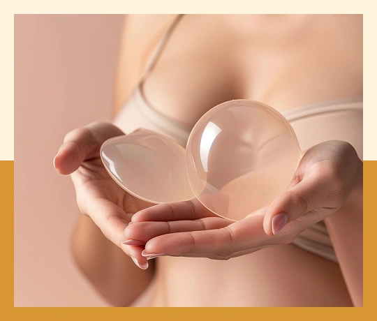 Breast implant held by surgeon representing breast augmentation and enhancement surgery.